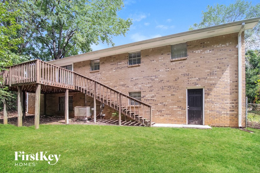 a large brick building with a wooden deck on the side