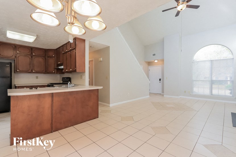 A kitchen with brown cabinets and a white countertop.