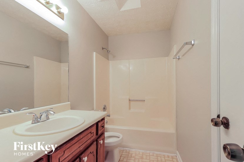 A bathroom with a sink, toilet, and bathtub.