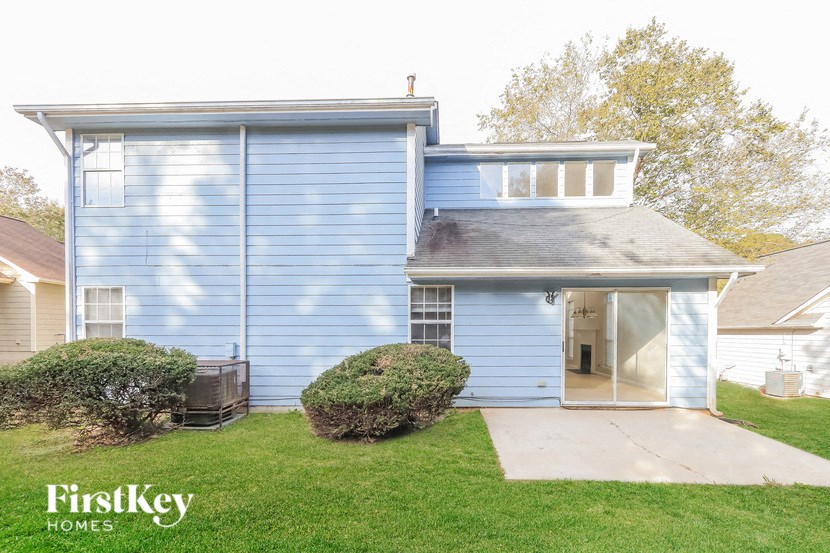 A blue house with a white roof and a garage door.