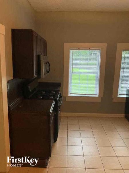 a kitchen with a stove and a window