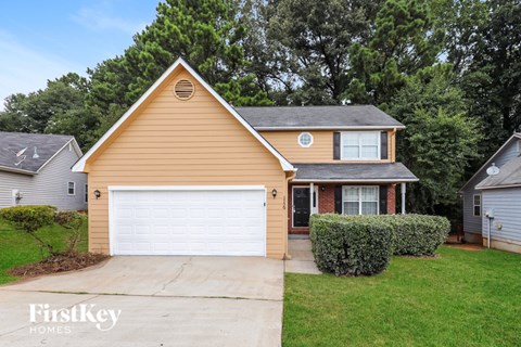 A house with a brown roof and a white garage door is for sale.