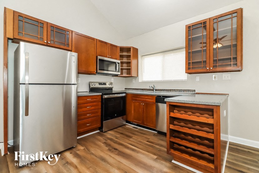 a kitchen with stainless steel appliances and wooden cabinets
