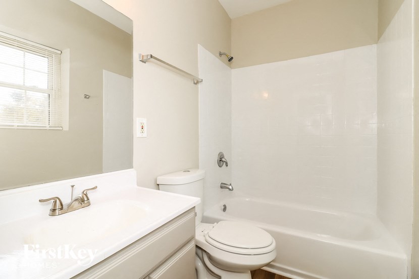 a bathroom with a sink toilet and a bath tub