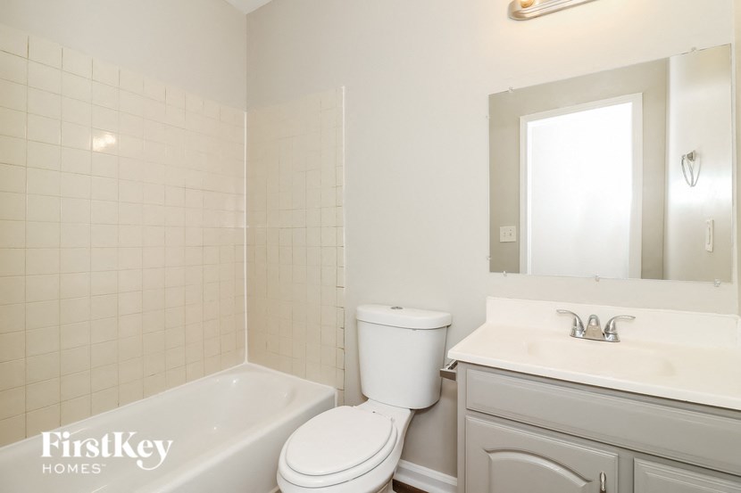 a white bathroom with a toilet sink and tub