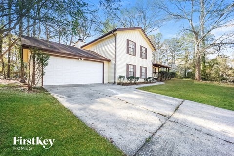 a white house with a driveway in front of it
