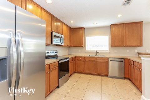 a kitchen with stainless steel appliances and wooden cabinets