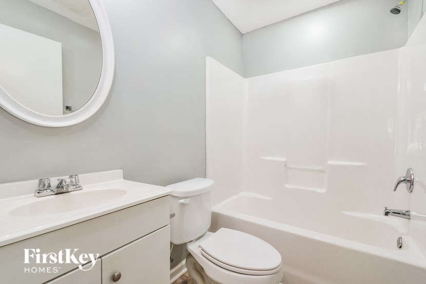 a bathroom with a sink toilet and a bath tub
