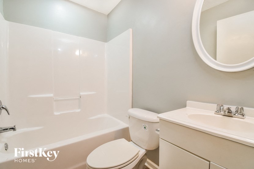 a white bathroom with a toilet and a sink