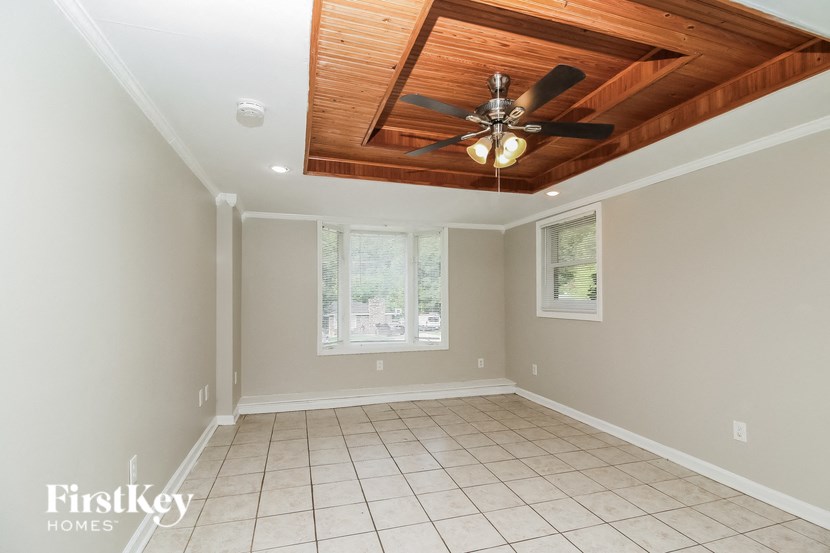 an empty dining room with a ceiling fan and tiled floor