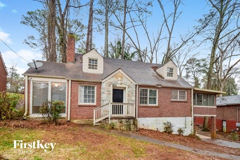the front of a brick house with a porch and a