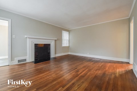 a living room with wood floors and a fireplace
