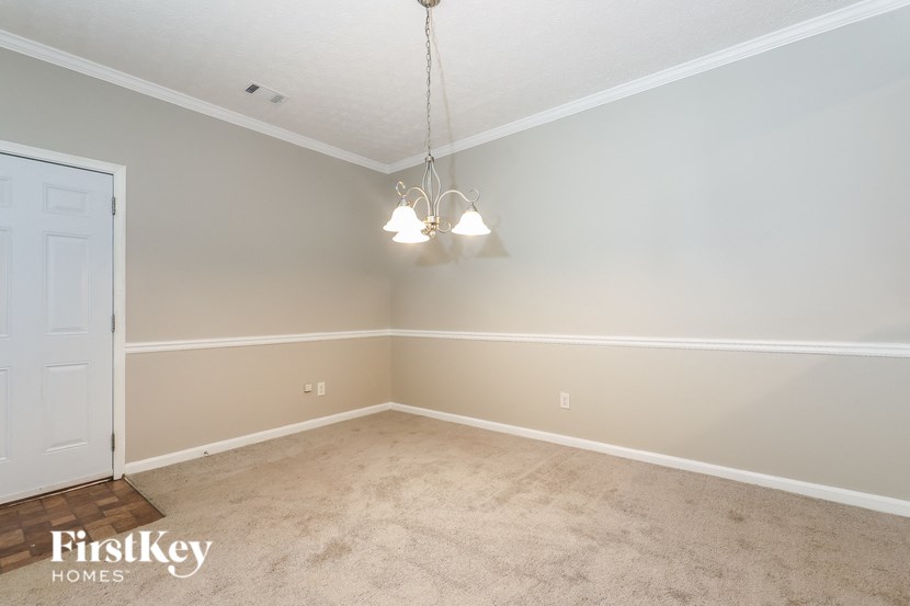 a bedroom with a carpeted floor and a white door