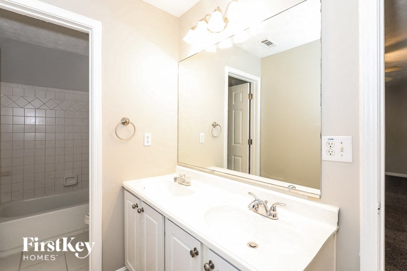 a bathroom with a white sink and a mirror