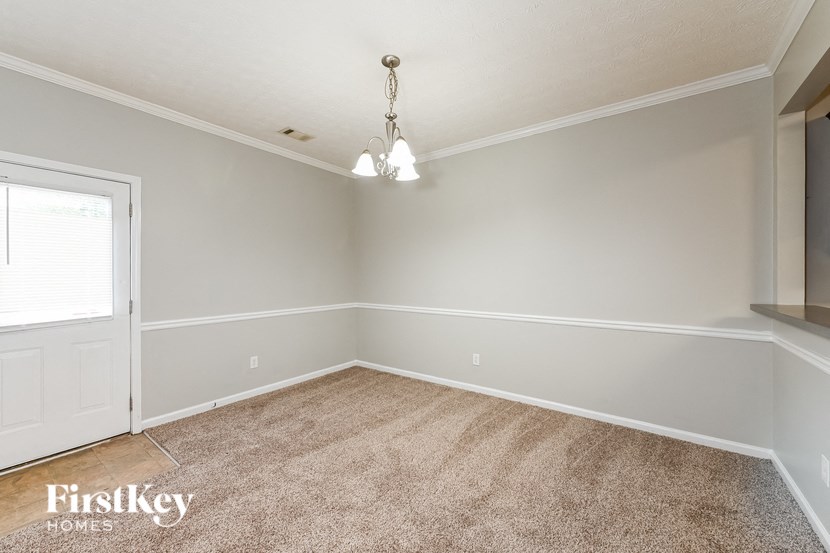 a bedroom with a carpeted floor and a door to a closet