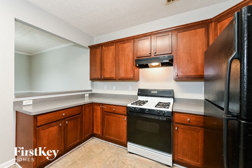 a kitchen with black appliances and wooden cabinets