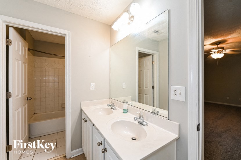 a bathroom with a sink and a mirror and a shower