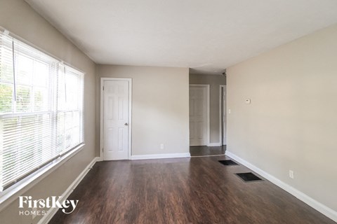 A room with wooden floors and a white door.