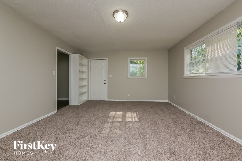 a empty room with a closet and a window