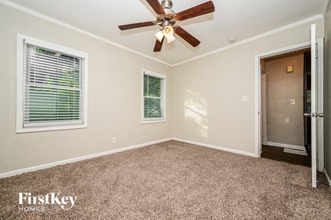 the master bedroom has a ceiling fan and a door to the closet