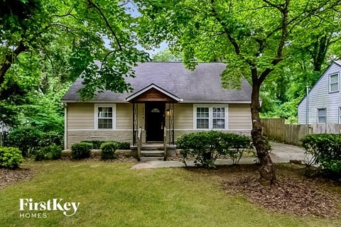 a small house with a yard and some trees