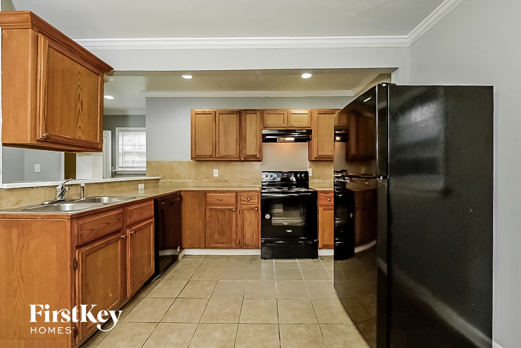 a kitchen with black appliances and wooden cabinets