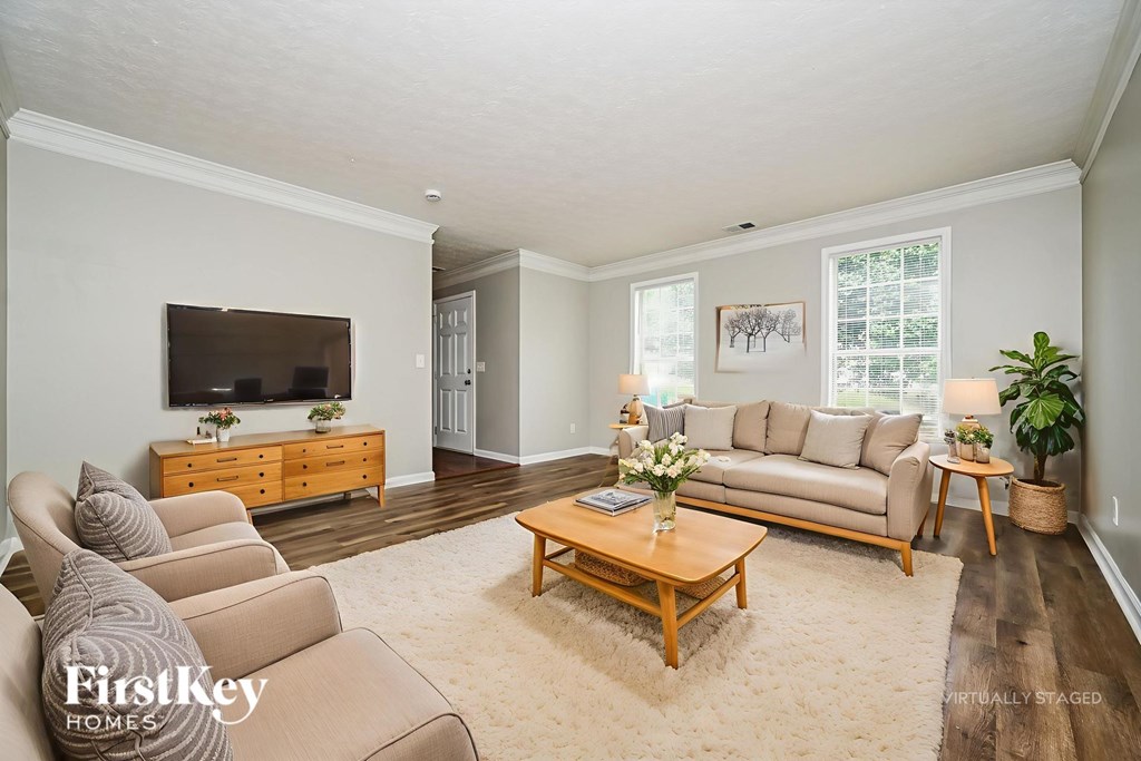 A living room with a couch, chair, and coffee table.