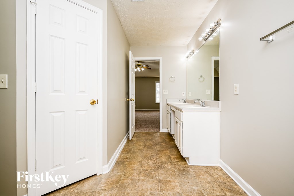A bathroom with a white door and a white sink.