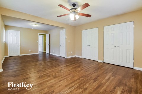 a living room with a ceiling fan and a wood floor
