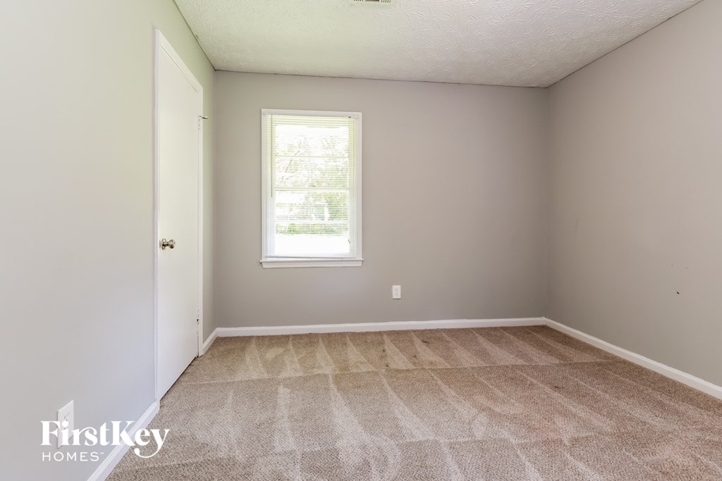 a room with a carpeted floor and a window