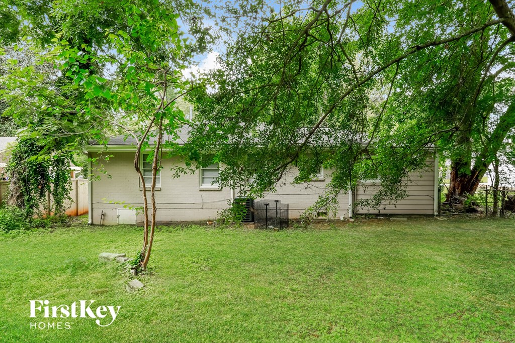 a white house with trees in front of it