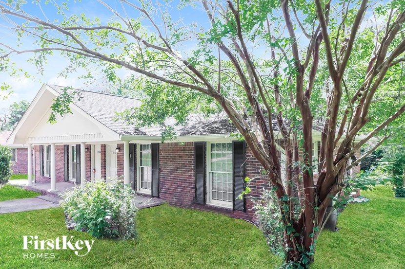 A house with a tree in front of it.