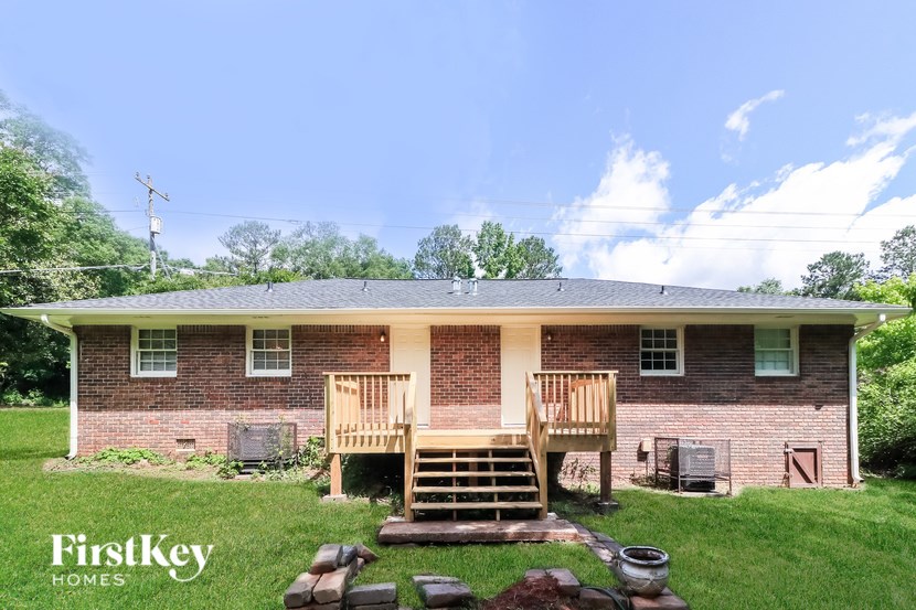 A brick house with a wooden deck in front.