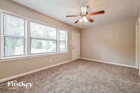 the master bedroom is spacious and has a ceiling fan
