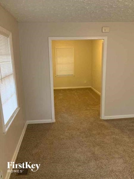 an empty room with a door and a window