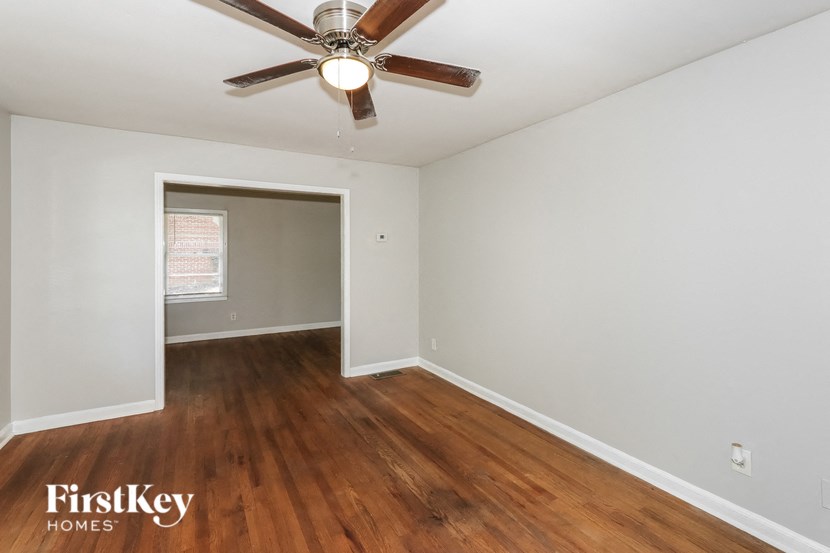 a bedroom with hardwood flooring and a ceiling fan