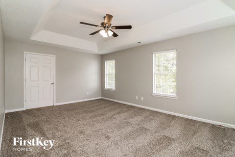 the master bedroom is spacious and has a ceiling fan