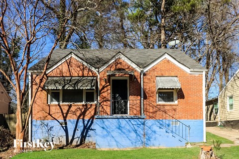 A red brick house with a blue painted wall.