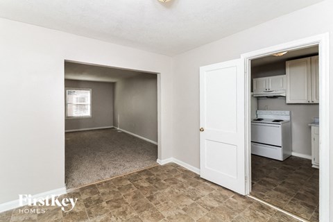 A kitchen area with a fridge, dishwasher and oven.