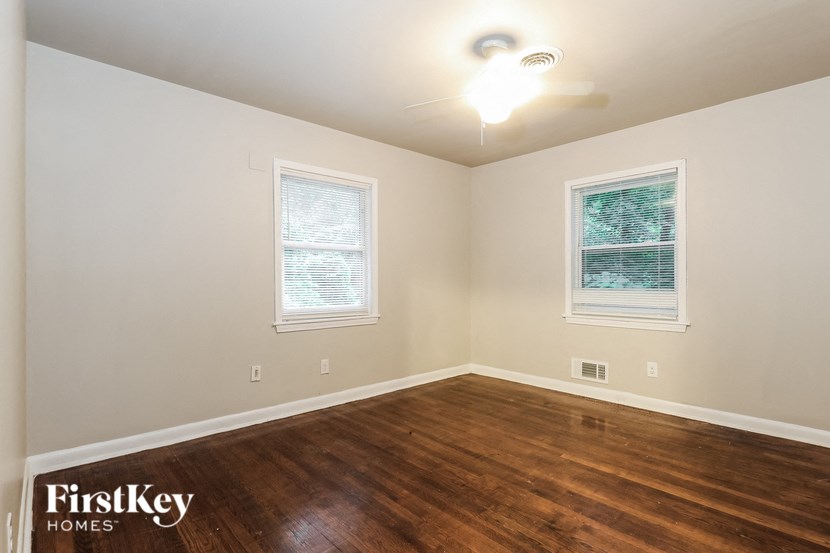 a living room with a hard wood floor and a ceiling fan