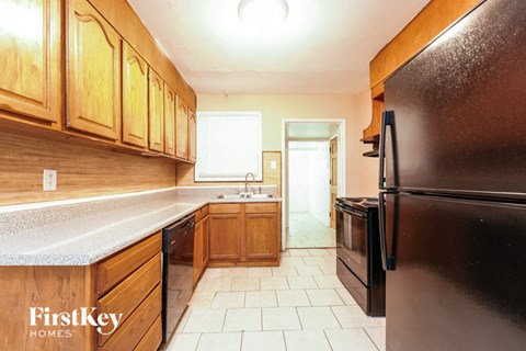a kitchen with black appliances and wooden cabinets