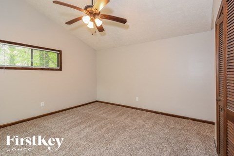 the master bedroom is spacious and has a ceiling fan