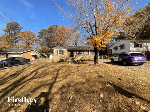 a house with a purple car parked in front of it
