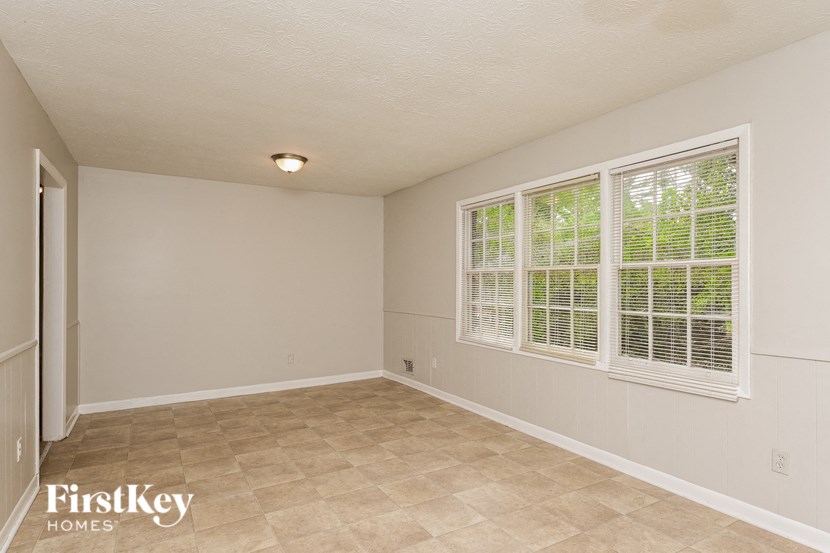the living room of an empty house with a large window