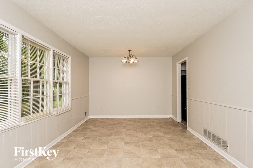 an empty living room with a large window