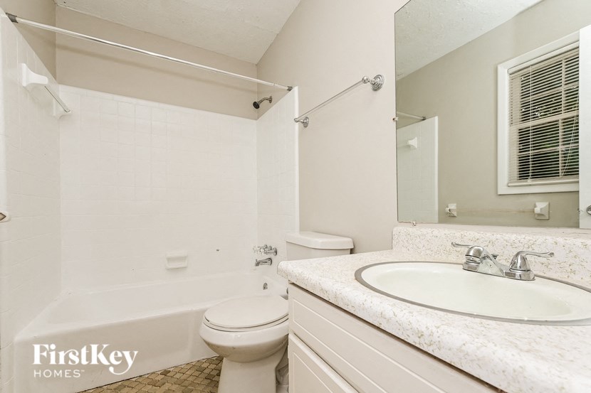 a bathroom with a sink toilet and a bath tub
