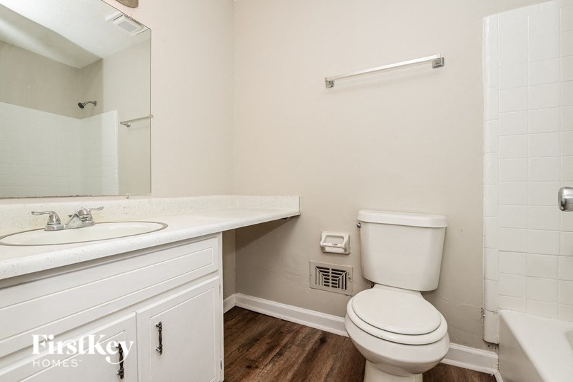 a bathroom with a toilet and a sink and a mirror
