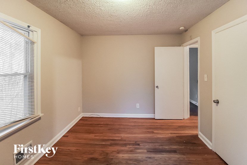 the living room of an empty house with a wood floor