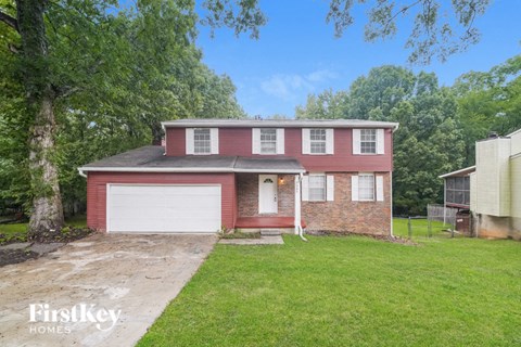 a red brick house with a white garage door