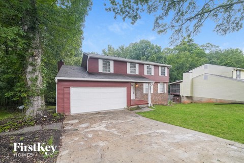 a red brick home with a white garage door